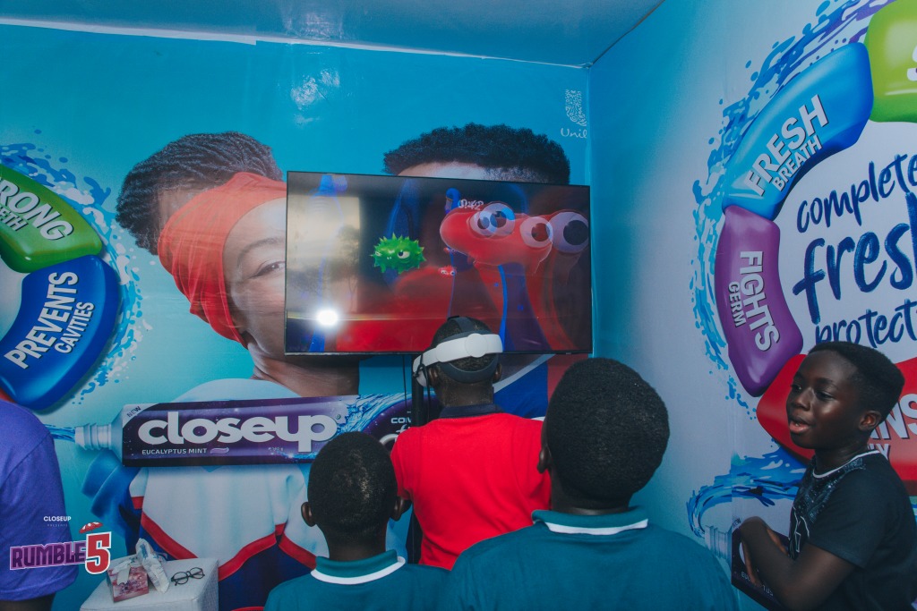 Young people trying a virtual reality headset inside a CloseUp branded booth