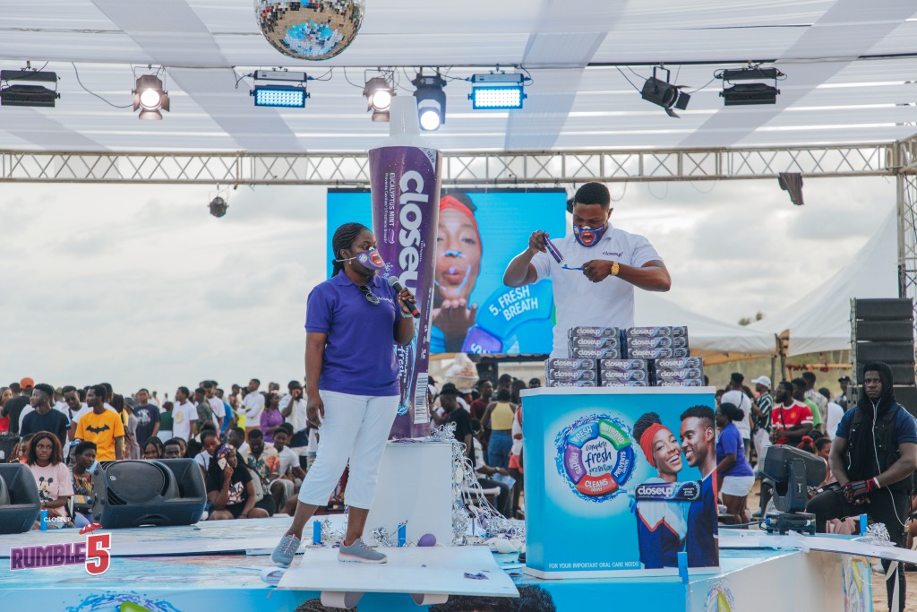 A host on stage addressing a large crowd at a CloseUp activation