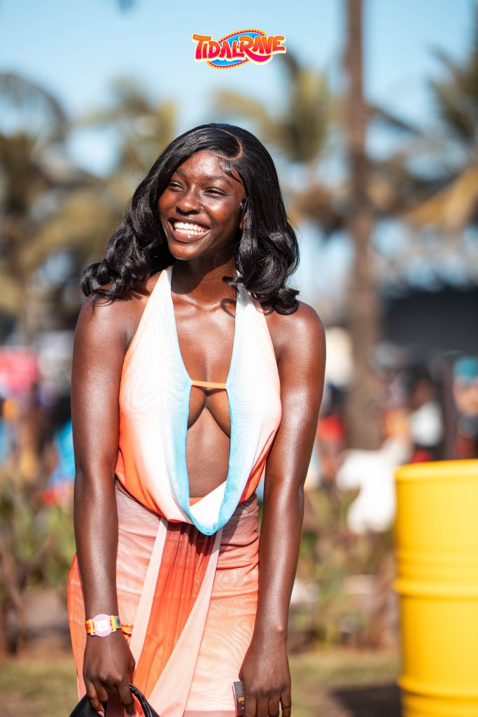 A festival-goer posing in front of the Tidal Rave stage