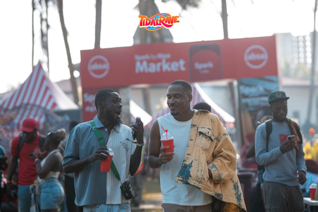 Festival-goers walking through the branded market area at the festival