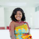 Portrait of a woman wearing a kente-patterned dress