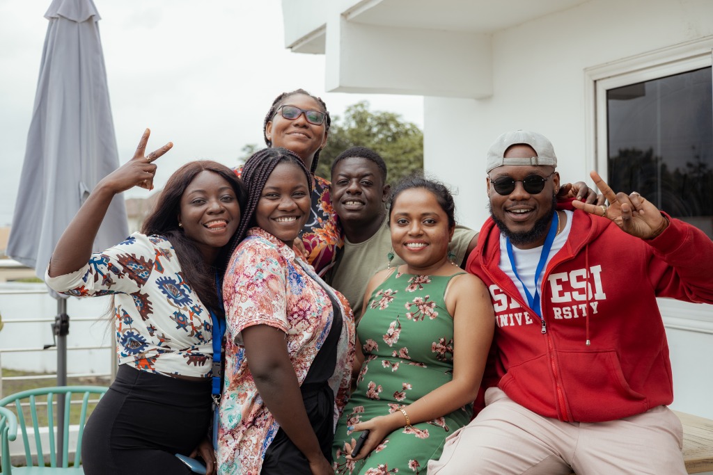 A group of colleagues posing together outdoors at the farewell gathering